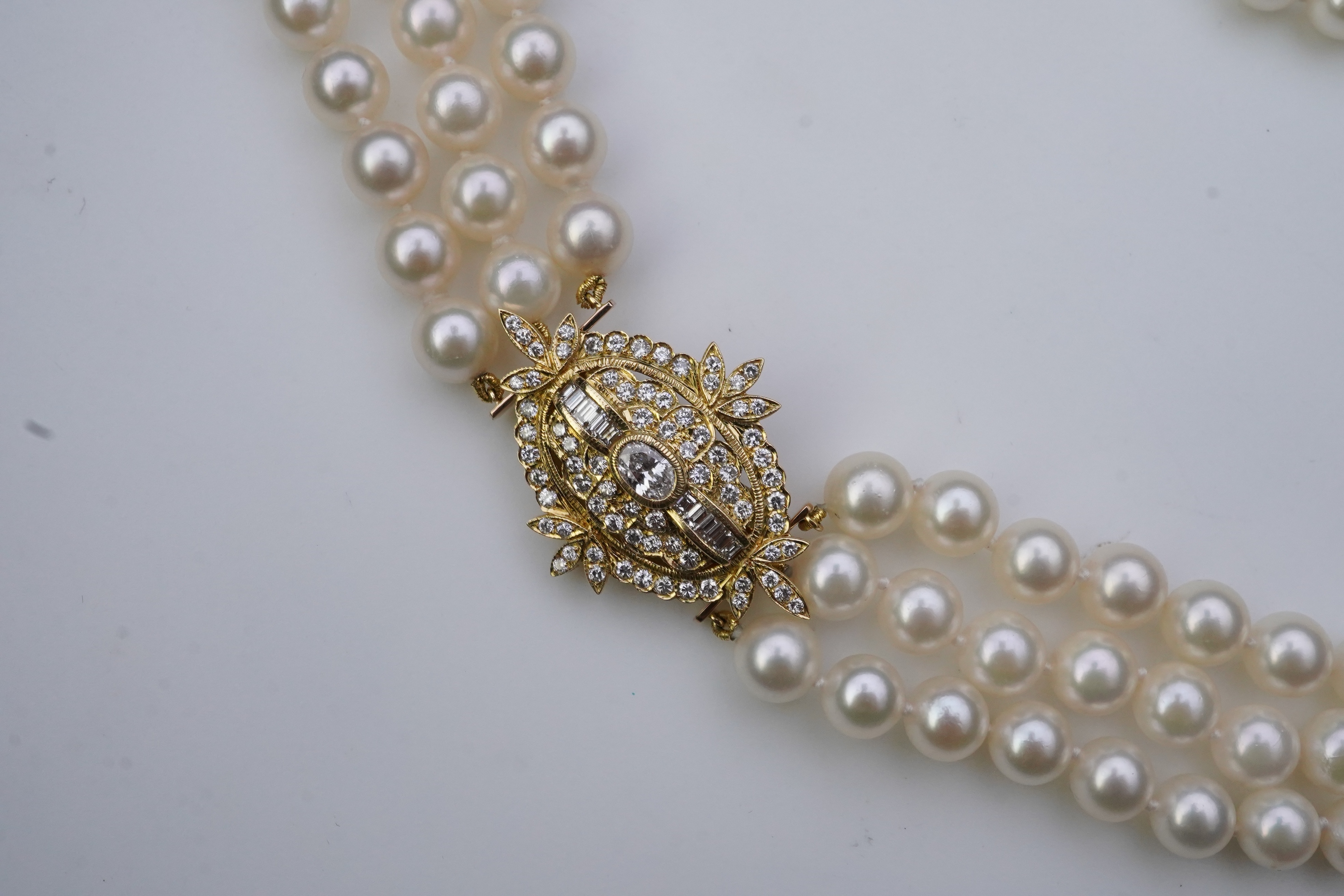 A cultured pearl and diamond necklace/brooch